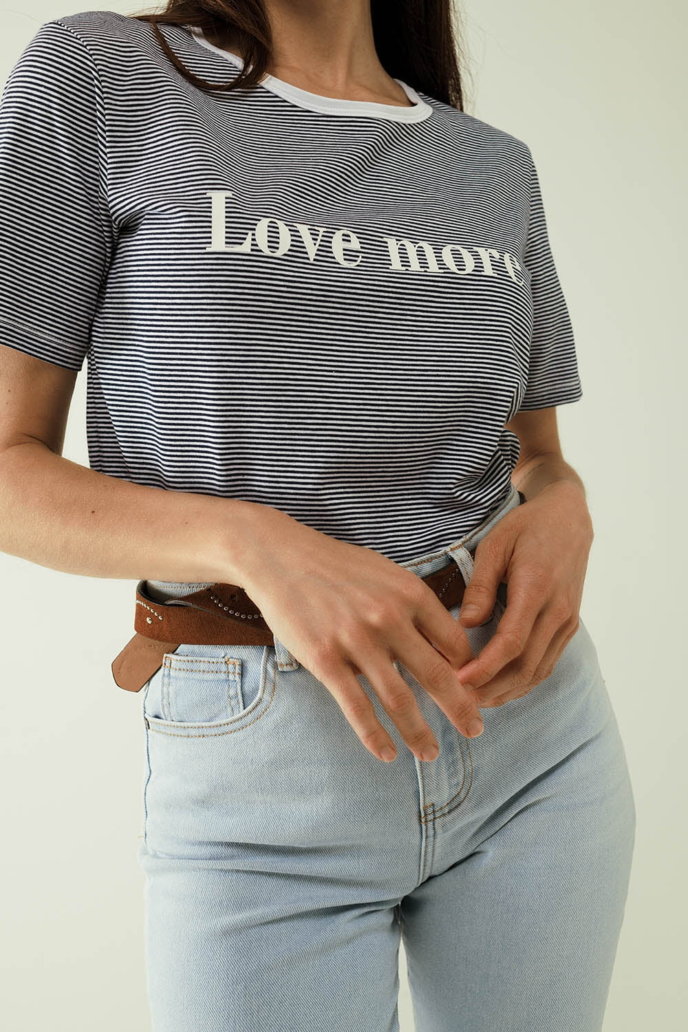 Camiseta blanca con rayas negras y texto Love More Q2