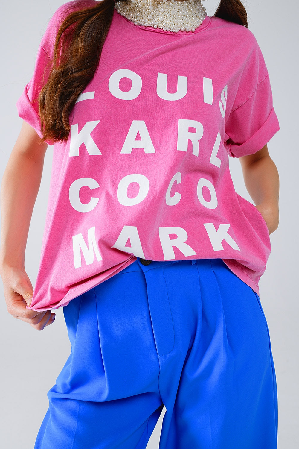 Camiseta fucsia con logotipos de nombres famosos en la parte delantera Q2