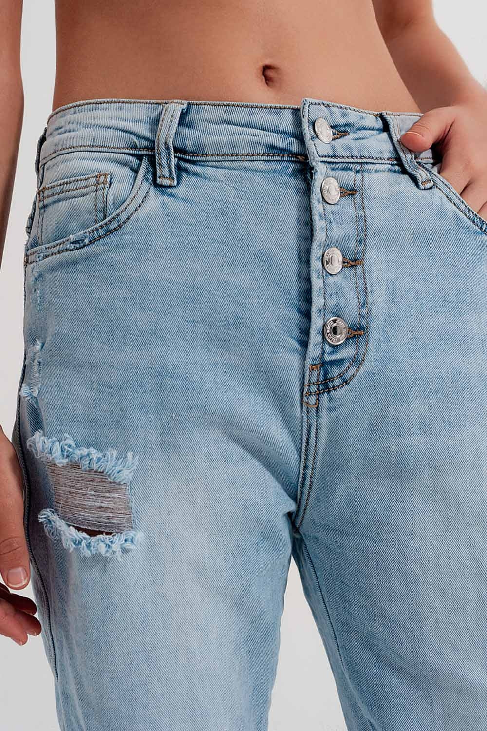 Vaqueros azul claro desgastados de pernera recta con rotos y detalle de botones Q2